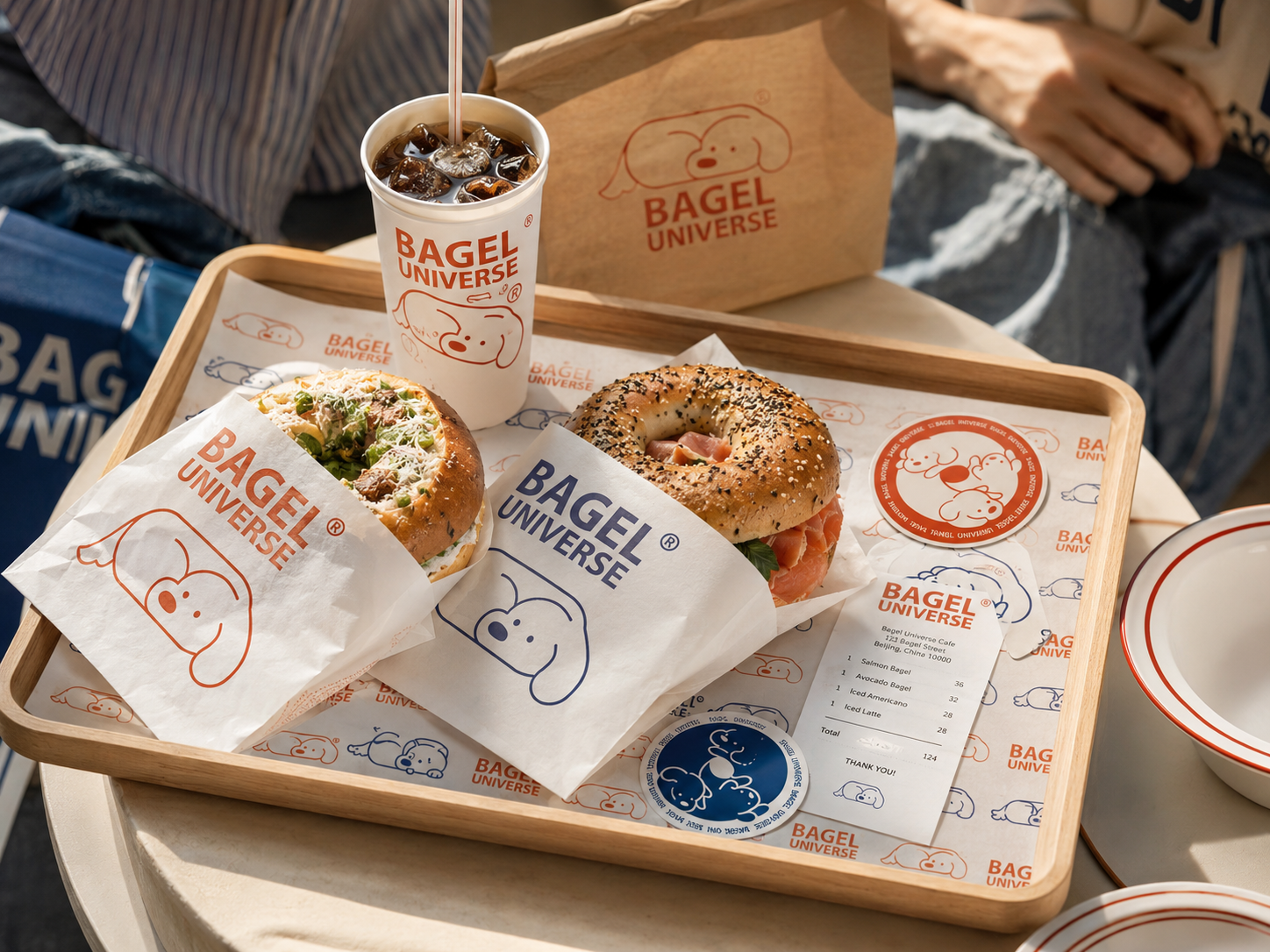 Bagel Universe dining tray with bagels, coffee and printed paper