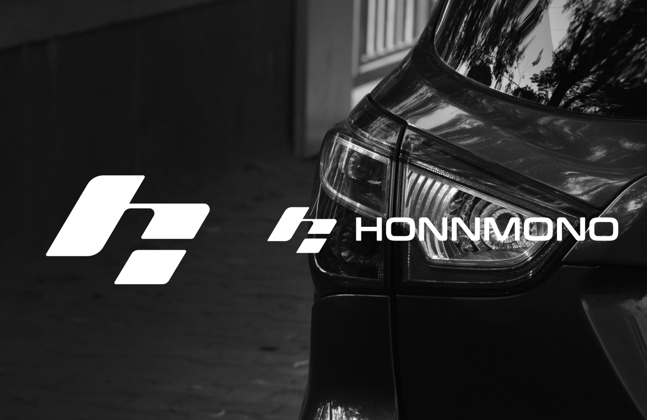 HONNMONO logo and symbol over a monochrome electric vehicle image